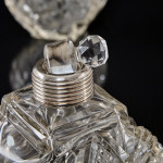 Pair of large Victorian cut glass & sterling-silver-mounted perfume bottles