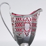 Victorian pierced sterling silver & cranberry glass cream jug