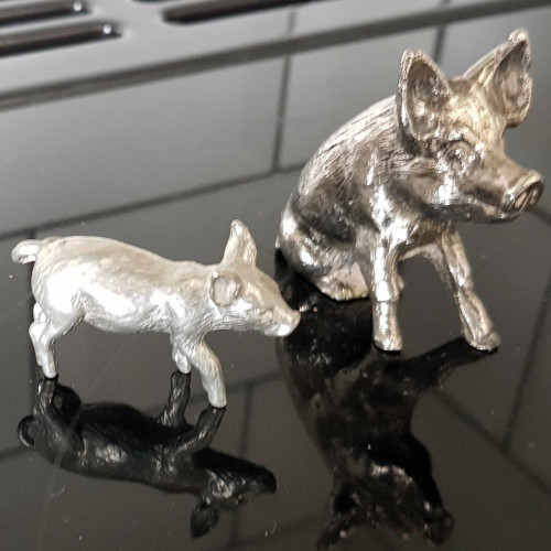 2 silver plate pigs