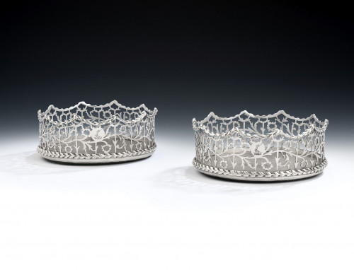 A very rare pair of George III silver based "Coronet" Wine Coasters made in London in 1770, maker's mark of T.L, in a serrated punch, see Grimwade mark 3845.
