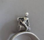 An extremely rare pair of Sugar Tongs modelled as a pair of Fire Irons, with a boy on a barrel above.  Made in London in 1853 by Francis Higgins.