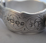 An extremely rare pair of Sugar Tongs modelled as a pair of Fire Irons, with a boy on a barrel above.  Made in London in 1853 by Francis Higgins.