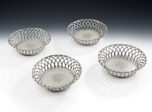 A very rare set of four early George III Wirework Silver based Magnum Wine Coasters made in London in 1764 by John Henry Vere & William Lutwyche.