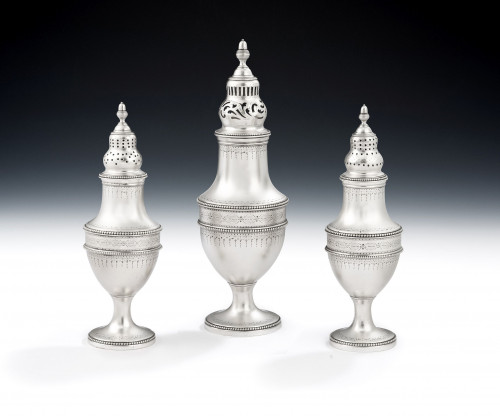 An exceptionally fine set of three George III Classical beaded casters made in London in 1784 by Thomas Daniel.