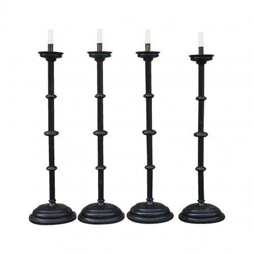 A Set Of four Large Floor Standing Candlesticks