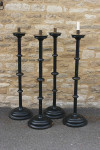 A Set Of four Large Floor Standing Candlesticks