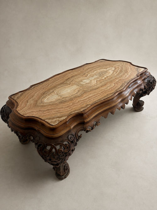 A C19th carved low Italian carved walnut table with onyx top