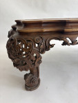 A C19th carved low Italian carved walnut table with onyx top