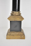 Large and heavy gilt metal table lamp in the form of an ebonised Corinthium column