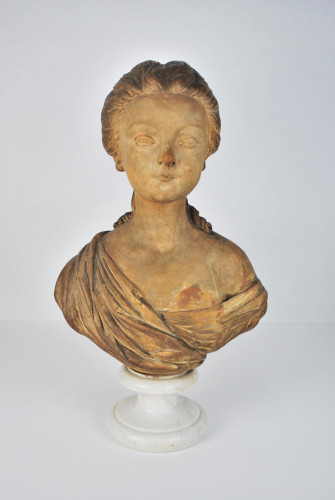 Terracotta bust of a young woman, 19th century, French, raised on a marble socle base