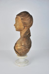 Terracotta bust of a young woman, 19th century, French, raised on a marble socle base