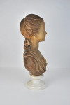 Terracotta bust of a young woman, 19th century, French, raised on a marble socle base