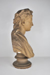 An antique plaster bust portrait of the young virgil after John Cheere, wearing a laurel wreath and toga, on a turned socle