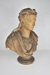 An antique plaster bust portrait of the young virgil after John Cheere, wearing a laurel wreath and toga, on a turned socle